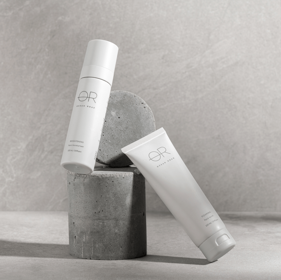 glowing skin care products captured on a grey background