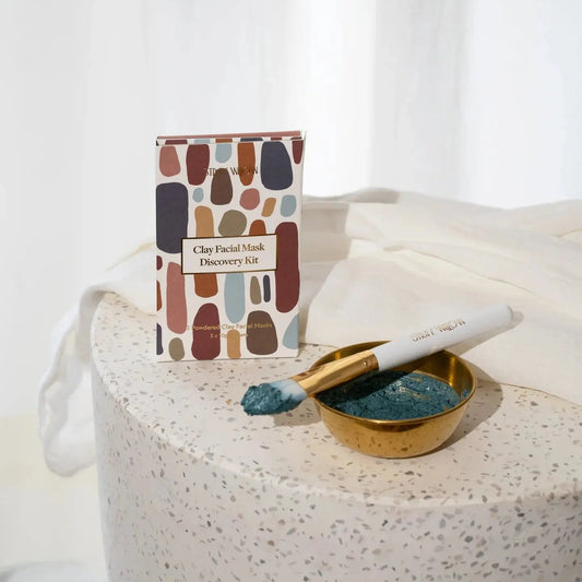 Natural clay face mask set, a blue tansy face mask mixed up in a brass bowl dish with a face mask brush for glowing skin