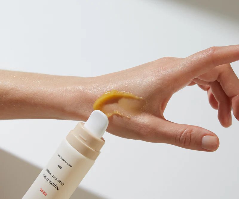 nipple balm for postpartum recovery being applied on a persons hands