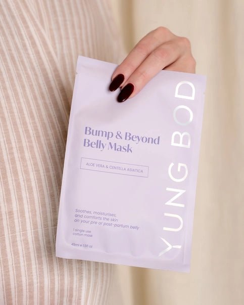 a person holding a postpartum sheet mask in their hand
