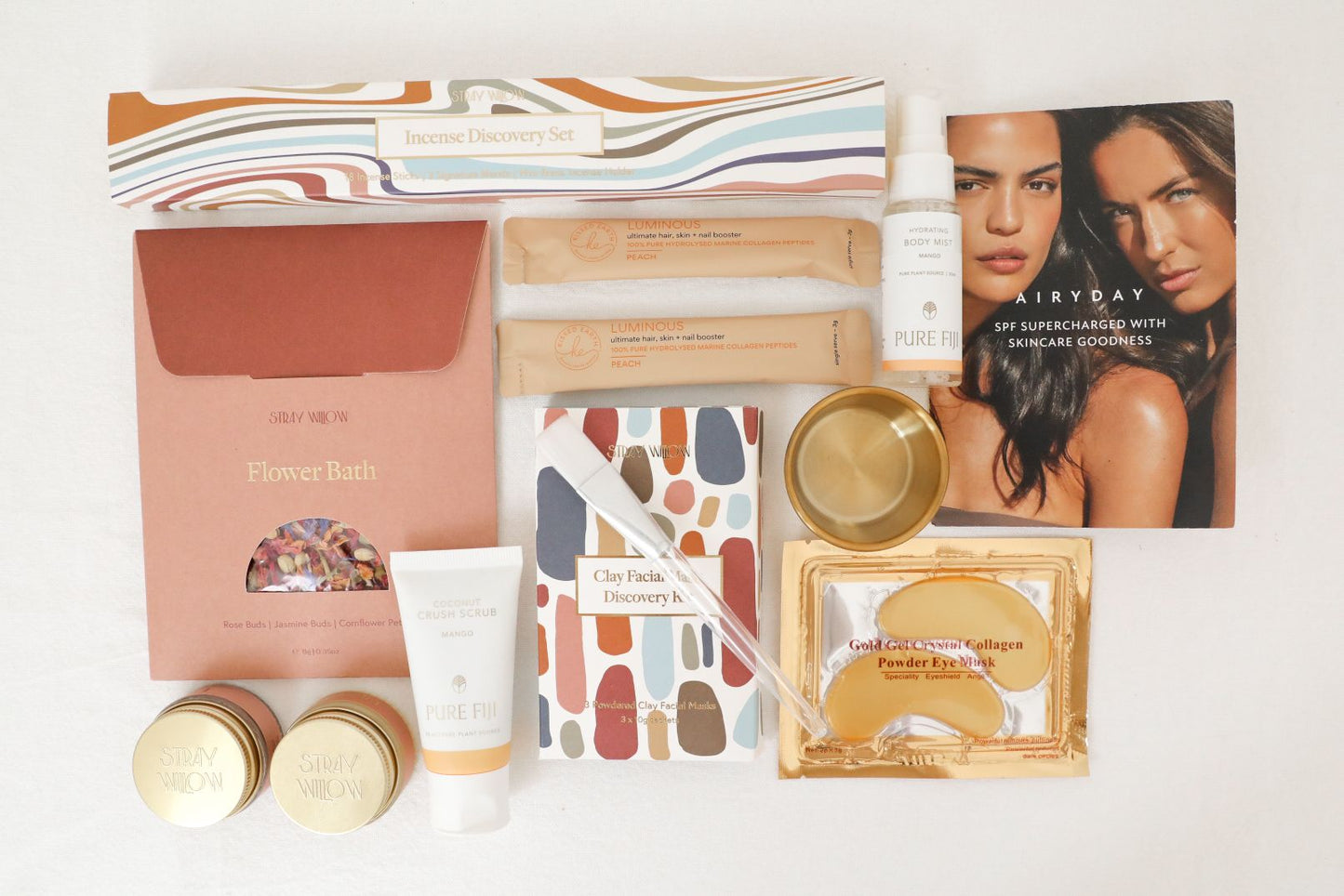 A flat layout of the self-care box filled with luxury cosmetics,